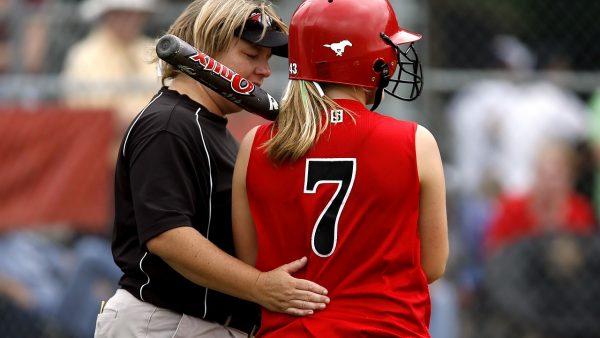 Coach guiding student athlete and givign moral support