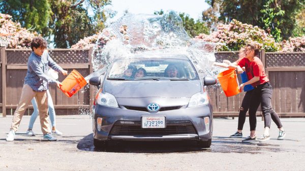 Students helping booster club at car wash fundraiser