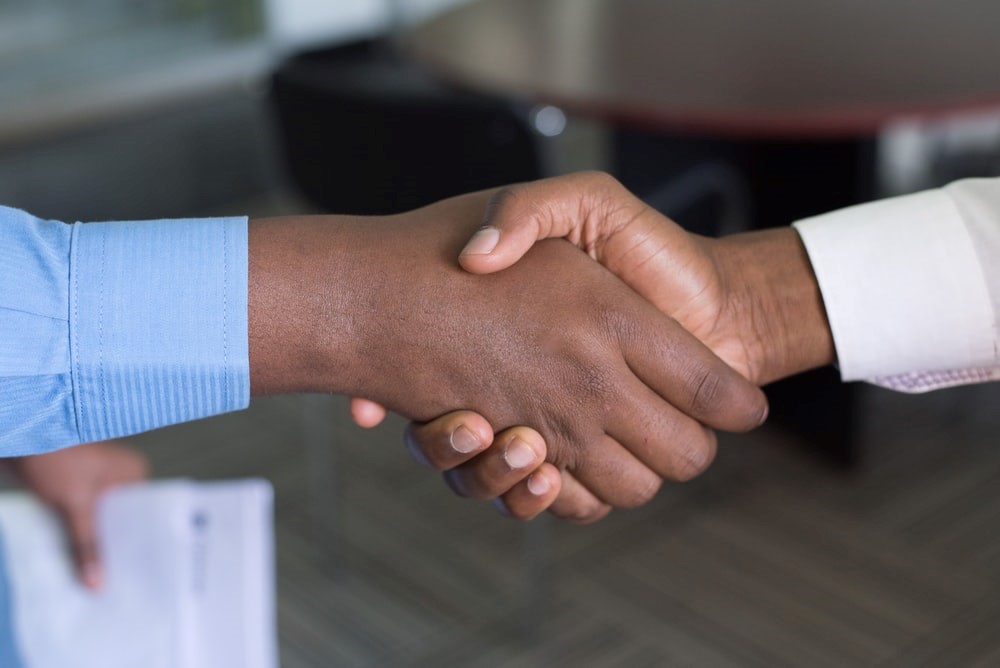 Two people giving a handshake,